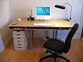 I sit at a desk.