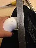 Sanding the edges down so that the wheel spins properly with out any obstruction.