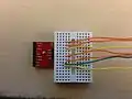 Take the breadboard and plug in the wires as shown. The color of the wires is irrelevant as long as you remember which wire is associated with which output from the IMU. For example, the green wire in this photo is associated with the ground, or 'GND', on the IMU.